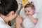 Latina mother caressing and pampering her beautiful baby girl