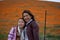 Latina Mother and Daughter in front of desert California Poppy field orange bokeh