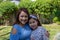 Latina Mother and Daughter Smiling and laughing outside in back yard