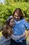 Latina Mother and Daughter Smiling and laughing outside in back yard