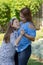 Latina Mother and Daughter Smiling and laughing outside in back yard