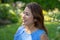 Latina Mother Smiling in Back Yard in front of red leaved bush