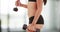 Latina woman lifting dumbbells