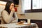 Latina woman smelling coffee before starting breakfast in her kitchen. Copy space