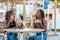 Latina women enjoying tasty takeaway food at an outdoors terrace