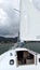 Latino adult man drives a sailboat on the lake with sails unfurled as a physical activity, sport and hobby to relax for the weeken