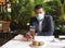 Latino adult man with protection mask in restaurant with drink and food, new normal covid-19