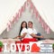 Latino adult man woman couple demonstrate love under a teepee with a sign that says `love and family` very much in love and happy