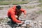 Latino American male tourist in active wear getting fire with matches for cooking on metallic burner