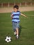 Latino boy playing with soccer ball