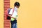 Latino boy with uniform shirt, mask, backpack, notebook and bottle of water back to school in the new normal due to the Coronaviru