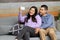 Latino couple of man and woman spend time together, see photos on their cell phone and make purchases and are surprised with disco
