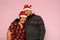 Latino couple with overweight body positive wearing santa hats are happy and excited about the arrival of December and celebrating