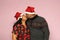 Latino couple with overweight body positive wearing santa hats are happy and excited about the arrival of December and celebrating