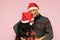 Latino couple with overweight body positive wearing santa hats are happy and excited about the arrival of December and celebrating