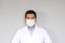 Latino doctor with a clinical gown and face masks for protection from the covid-19 virus