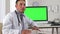 Latino doctor talking with green screen on computer in background