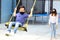 Latino family, mom and 6-year-old boy with face masks playing swing, new normal by covid-19