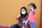 Latino family, woman and 5-year-old girl with covid-1 protection mask, ready for back to school