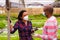 Latino farmers in protective medical masks talk in between work