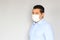 Latino man with clinical use mouth masks for protection from covid-19 virus