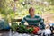 Latino man sits at table with ripe vegetables