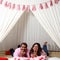 Latino man and woman couple in love and happy share their love with kisses and hugs under a teepee and the sign that says `love` c