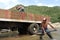 Latino Men loading truck with sand with shovel