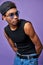 Latino transgender model in casual pose close up portrait. Muscular male in cap, t-shirt with glasses