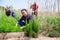 Latino woman cultivates rosemary plants on a field