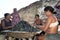 Latino women peel together mussels, Brazil