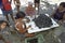 Latino women peel together mussels, Brazil