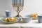Latkes on a plate, Hanukkah, cups with milk on a white tablecloth