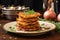 latkes stacked high on a ceramic dish with a parsley garnish