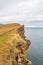 Latrabjarg in Iceland cliff coast an nesting place of millions of Atlantic puffins overgrown edge of cliff and downwards view