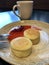 Latte with cinnamon and cheesecakes with strawberry jam