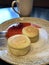 Latte with cinnamon and cheesecakes with strawberry jam