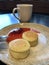 Latte with cinnamon and cheesecakes with strawberry jam