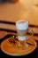 Latte macchiato coffee Served with cookie in brown earth tone color background