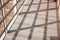 Lattice shadow on the terrace. Wooden floor, panoramic windows, abstract background