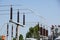 Lattice-type steel tower fragment over blue sky as a part of high-voltage line. Overhead power line details