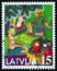 LATVIA - CIRCA 1999: A stamp printed in Latvia from the `Christmas` issue shows Children watching television, circa 1999.