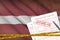 Latvia flag and Health insurance claim form with covid-19 stamp. Coronavirus or 2019-nCov virus concept