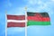 Latvia and Malawi two flags on flagpoles and blue sky