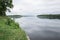 Latvia. Old river and green trees. Ruins and reflection.