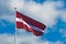 Latvian flag waving in the sky, Baltic countries