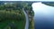Latvian rural landscape with a winding river, forests and country roads, aerial top view. Daugava river