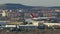 Lauda airplane flying against Madrid cityscape with industrial area