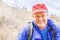 Laughing adult man in a baseball cap with a backpack