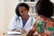 Laughing african american female doctor with patient